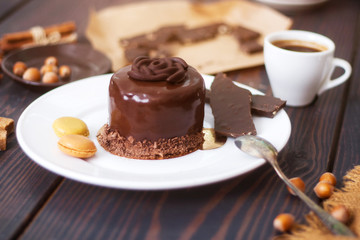 Chocolate cake on a white plate close-up.