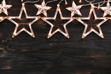 Beautiful glowing garland on dark wooden background