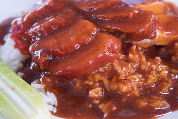 Barbecued red pork in sauce with served in dish.