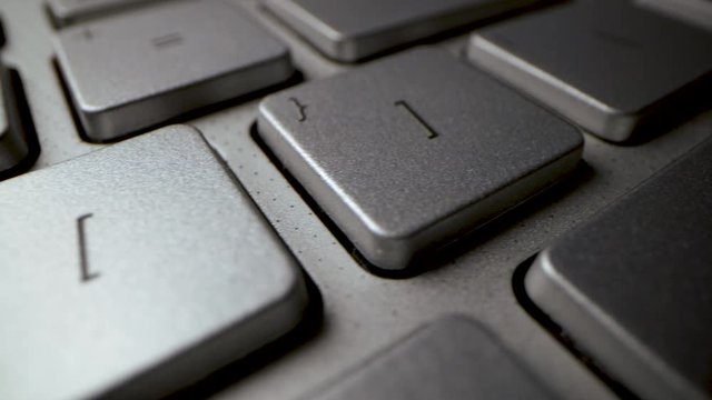 sliding over laptop computer keyboard. enter key