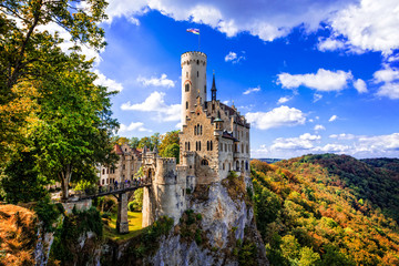 Medieval Lichtenstein Castle on Steep Cliff Edge in Swabian Alps, Fairy Tale German Gothic Architecture, Impressive Fortress over the Rock and Forest, Romantic Landmark in Baden-Wurttemberg Germany © Freesurf