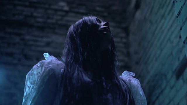 Evil witch screaming and saying spell to call spirits from hell for sabbath