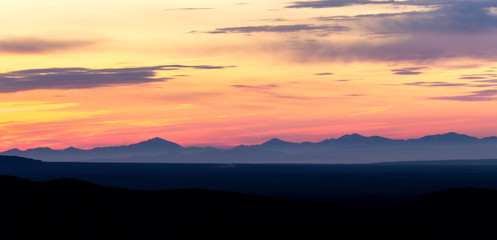 Fototapeta na wymiar Sunrise in the mountains, the rays of the sun breaking through the clouds. Kamchatka Peninsula, Russia