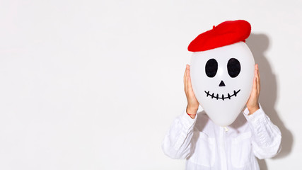 Woman with ghost balloon head in red hat on white