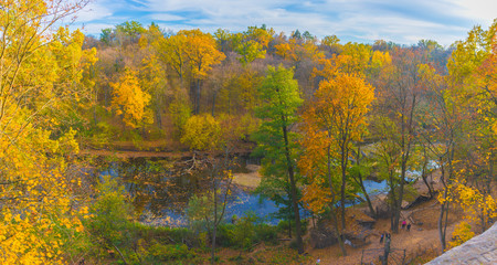 Panorama of autumn landscape with colorful forest, river and forest trails