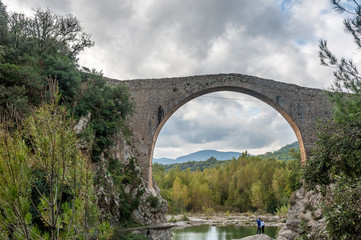View of the old medieval bridge of Llierca, in the region of La Garrotxa, Girona, Spain.