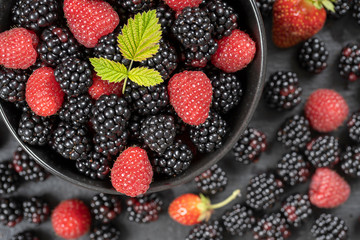 Background from fresh organic blackberries and raspberries, close up. Top view blackberry and raspberry