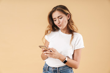 Portrait of displeased woman frowning while holding cellphone