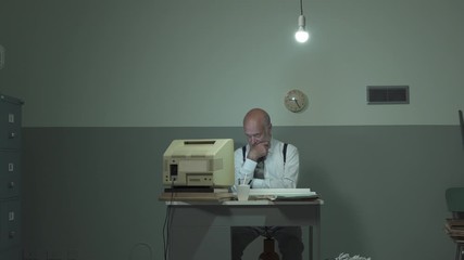 Bored office clerk staring at the computer screen