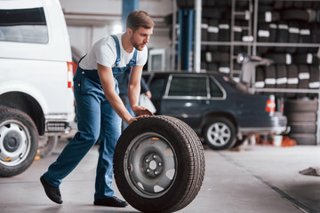 Going forward. Employee in the blue colored uniform works in the automobile salon