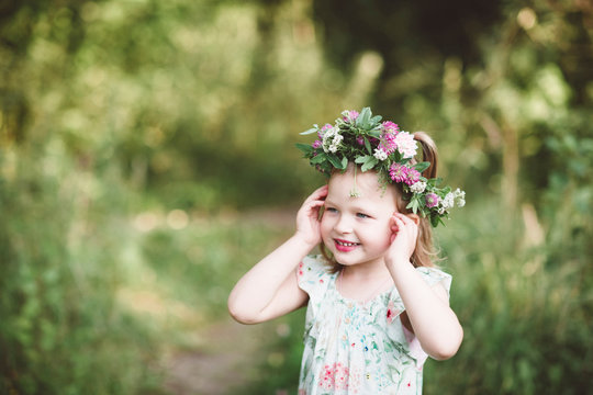 Portrait of smiling little girl with flower wreath