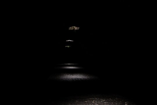 Dark tunnel with daylight entering through the holes creating mysterious image