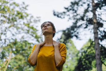 Young woman in a park looking up