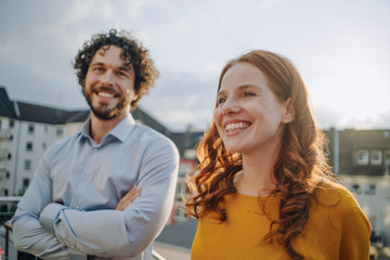 Two happy colleagues on roof terrace