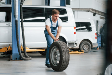 Be right back. Employee in the blue colored uniform works in the automobile salon