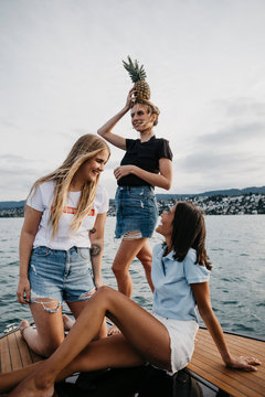 Happy female, friends having fun on a boat trip on a lake