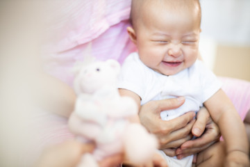 Asian baby happy in the room.Asian baby girl lying down on bed .