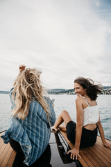 Fototapeta na wymiar Happy female, friends on a boat trip on a lake