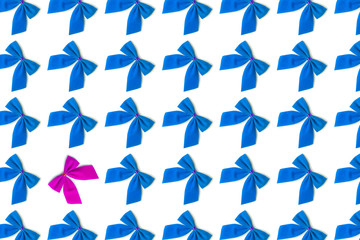 Fototapeta premium Blue bows, one pink on a white background, Christmas pattern, not like everything, unique, against the system.