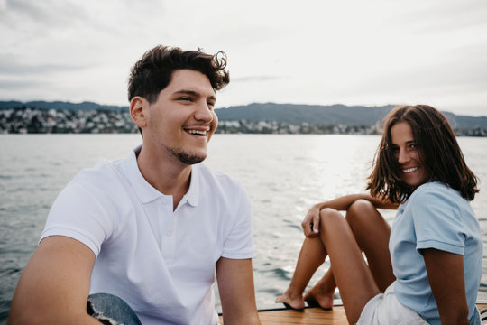 Happy young couple on a boat trip on a lake