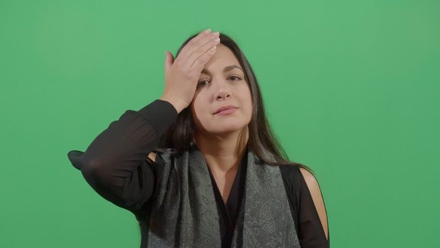 Woman Slapping His Forehead Suggesting Bad News Notice. Studio Isolated Shot Against Green Screen Background