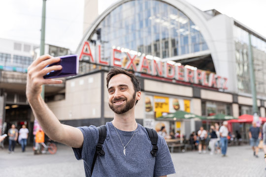 Man taking smartphone selfies, Berlin, Germany