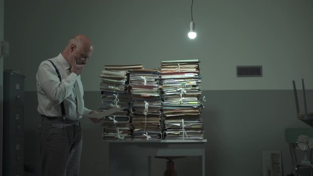 Corporate businessman and piles of paperwork