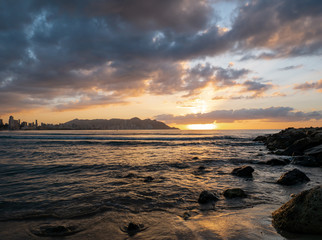  sunrise on rocky beach with orange light