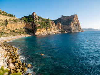  sunrise on beach with rocks in cala moraig