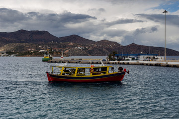 A fishing boat sails on the sea in bad weather.