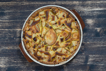 Homemade organic pear pie dessert ready to eat. Pear tart on the old wooden background, close up