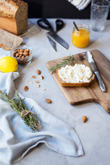 Cozy breakfast with freshly baked sandwiches and curd cheese sandwiches with almonds and lemon zest