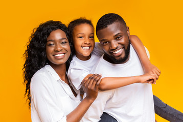 Portrait of positive black family of three