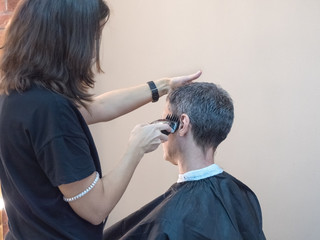 Man in barber chair, hairdresser haircut his hair. Barber shop. 