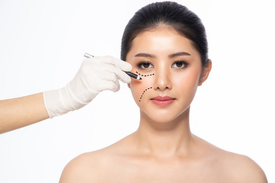 Lines on face, close up, plastic surgery concept, doctor's hand in glove making marks on patient's face..Asian beauty  Woman in beauty salon. plastic surgery clinic.