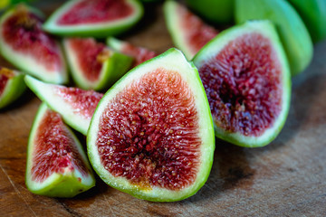 Fig - fresh figs and sliced fig fruits close-up on cutting board