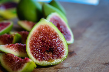 Fig - fresh figs and sliced fig fruits close-up on cutting board