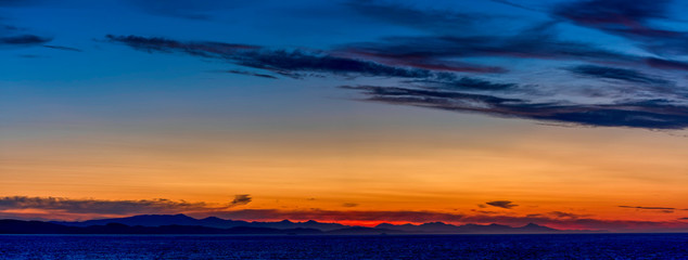 Fototapeta na wymiar Panorama of Sunset over Mountains, Sea