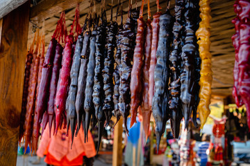Churchkhela candies hanging in front of market stall in Tbilisi, Georgia. Churchkhela is a traditional Georgian cuisine candle-shaped candy.