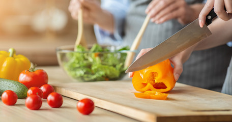 Two women hands making healthy veggies salad