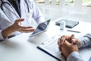 Doctor having conversation with patient while discussing explaining symptom