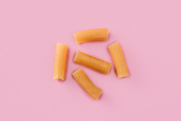 Fresh macaroni pasta isolated on pink background