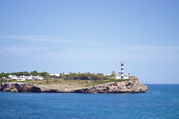Fototapeta na wymiar lighthouse on a land tongue in the ocean