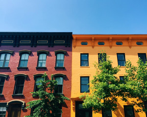 Low angle view of two buildings in contrast colors
