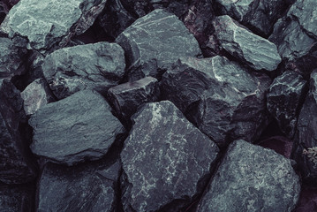 High angle view of pile of black rocks
