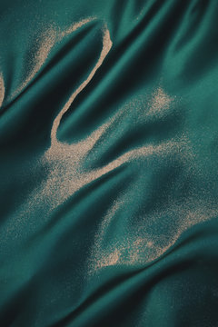 Sand on emerald green silk