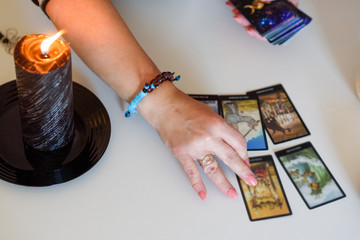 Close up woman hands with tarot cards. Card reading. Divination and clairvoyance.