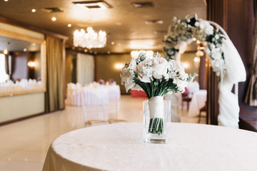 wedding table in restaurant. exit wedding registration. The bride's bouquet. flowers on the table. banquet hall.