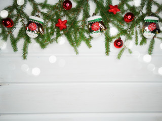 Fototapeta na wymiar christmas decoration and garland lights on white wooden background