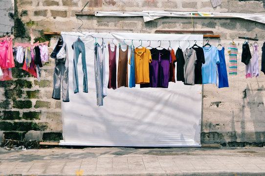 Clothing on clothesline in front of old building
